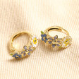 Pastel Enamel Floral Huggie Hoop Earrings in Gold on Beige Fabric
