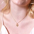 Close up of Enamel Birth Flower Outline Pendant Necklace in Gold on blonde haired model