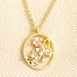 March Enamel Birth Flower Outline Pendant Necklace in Gold against neutral background