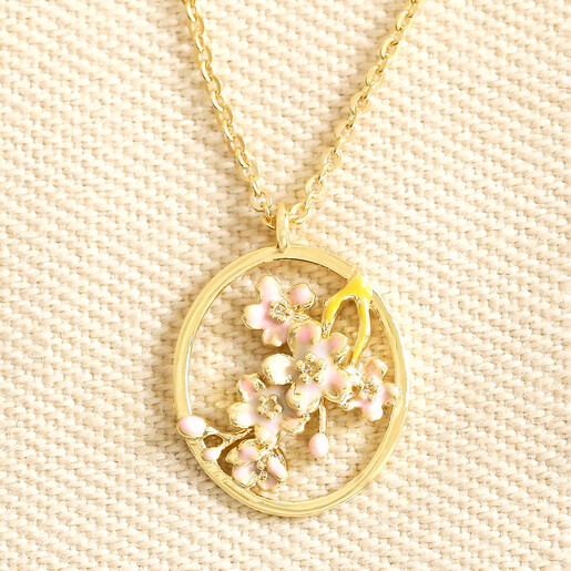 March Enamel Birth Flower Outline Pendant Necklace in Gold against neutral background