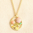 Close up of september Enamel Birth Flower Outline Pendant Necklace in Gold against beige fabric