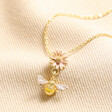 Yellow and Pink Enamel Floral Bee Pendant Necklace in Gold on Beige Fabric