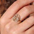 Close up of Adjustable Matte Floral Signet Ring in Gold on model
