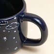 Close up of handle on Ceramic Midnight Blue Best Daddy in the Universe Mug against neutral background