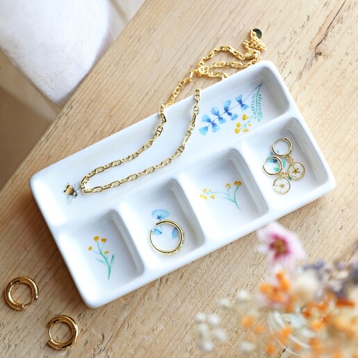 Cornflower Blue Floral Bee Ceramic Trinket Tray on top of wooden counter with jewellery inside