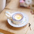 Mum Meaningful Word Handled Tealight Holder in lifestyle shot on wooden counter