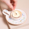 Model lighting tealight inside of Nana Meaningful Word Handled Tealight Holder