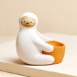 Ceramic Sloth Hug Egg Cup on Beige Surface