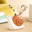 Tiny Snail Ceramic Bud Vase in lifestyle shot with flowers inside of vase