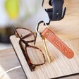 Close up of Personalised Engraved Wooden Phone Accessory Stand in Lifestyle Shot