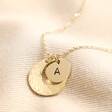 Close up of Personalised Crescent Moon Disc Pendant Necklace in all gold against beige backdrop