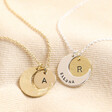 Personalised Crescent Moon Disc Pendant Necklaces with silver and gold charms against beige fabric