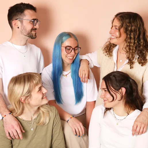 A group picture of five models posing with the bracelets and laughing