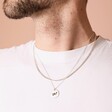 Model wearing two, layered silver chains. One of them is engraved with the bisexual charm.