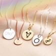 A mixture of gold and silver pendants with engraved symbols 