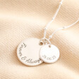Blackened engraving on Personalised Sterling Silver Double Disc Charm Necklace against beige material