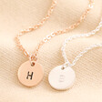 Personalised Sterling Silver Initial Disc Charm Necklaces in rose gold and silver against neutral fabric