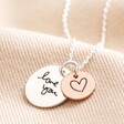 Large silver disc charm and small rose gold charm on Personalised 'Your Drawing' Double Disc Charm Necklace against beige background