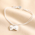 Personalised Mixed Metal Heart Bracelet in silver against beige coloured backdrop