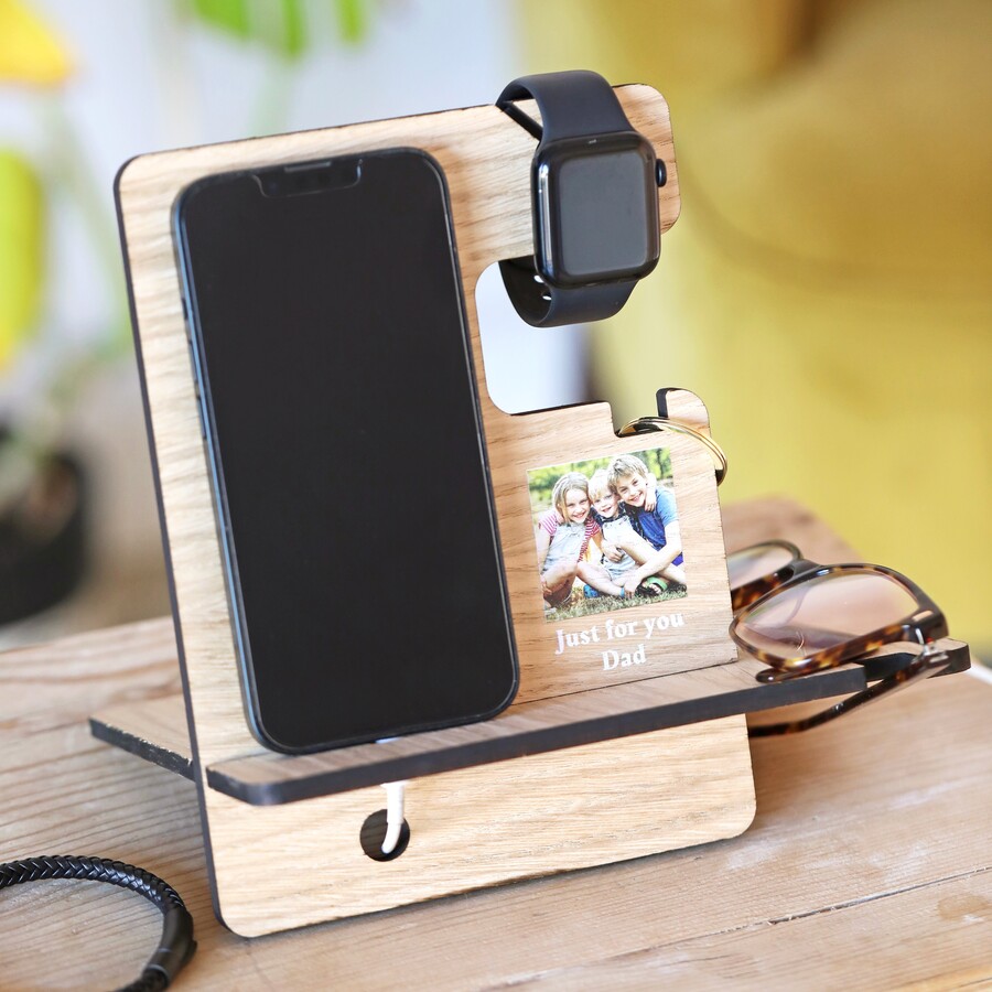 Personalised Photo Wooden Phone Stand with accessories on and phone in lifestyle shot