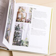 How to Plant a Room and Grow a Happy Home Book open showing inside pages against beige coloured backdrop
