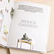 How to Plant a Room and Grow a Happy Home Book open against beige coloured background