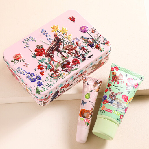 Heathcote & Ivory Nathalie Lete Forest Folk Hand and Lip Tin with products out of tin on beige surface