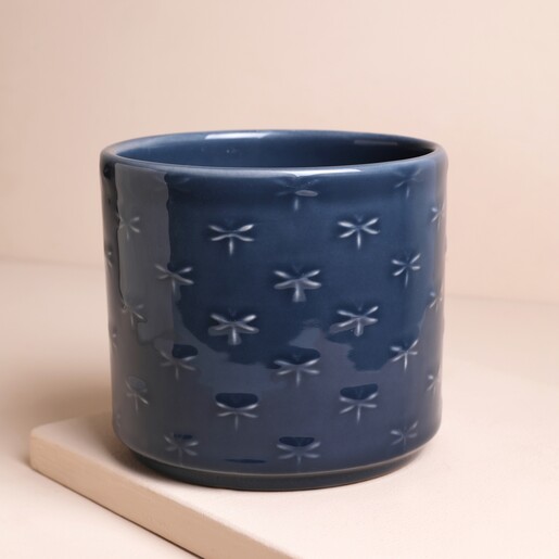 Ivyline Arley Blue Dragonfly Planter on top of raised surface against beige backdrop