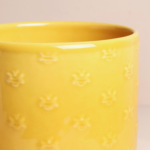 Close up of Ivyline Arley Yellow Bee Planter against neutral background