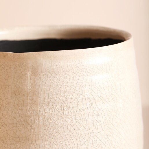 Close up of Ivyline Small Ivory Planter rim on a beige background