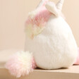 Back of Jellycat Amuseabean Unicorn Soft Toy against beige backdrop