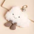 Jellycat Amuseable Cloud Bag Charm Laying on Pink Surface