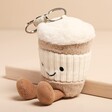 Jellycat Amuseable Coffee-To-Go Bag Charm sat against beige coloured background
