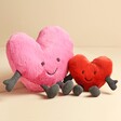 Jellycat Amuseable Large Pink Heart Soft Toy with small red heart against beige backdrop