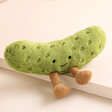 Jellycat Amuseable Pickle Soft Toy on top of raised surface