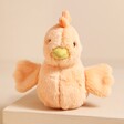Jellycat Fluffy Chicken Soft Toy on top of beige surface 