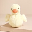 Jellycat Fluffy Duck Soft Toy in front of beige backdrop