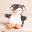 Jellycat Peanut Penguin Bag Charm Soft Toy on Beige Surface