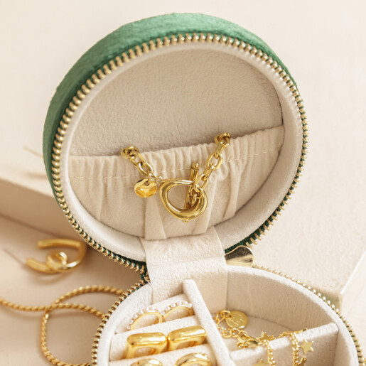 Top of lid in Personalised Quilted Velvet Mini Round Travel Jewellery Case in green against beige background