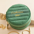 Personalised Quilted Velvet Mini Round Travel Jewellery Case in green against beige coloured background