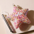 Personalised Hanging Pink Glitter LED Star Light unlit on top of beige coloured backdrop