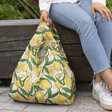 Kind Bag Lemons Reusable Shopping Bag out of packaging being held outside 