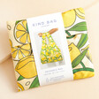 Kind Bag Lemons Reusable Shopping Bag in packaging against beige coloured backdrop