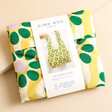 Kind Bag Wavy Daisy Reusable Shopping Bag in packaging against neutral coloured backdrop