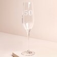 Personalised 50th Birthday Champagne Glass against beige coloured background