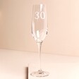 Personalised Milestone Age Champagne Glass against beige coloured background