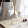 Personalised Wedding Initial Champagne Glass in lifestyle shot with model pouring into wine glass