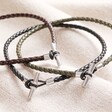 Men's Braided Vegan Leather T-Bar Bracelet in Brown with khaki and black version on top of beige coloured fabric