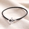 Men's Braided Vegan Leather T-Bar Bracelet in Black on top of beige coloured fabric