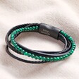 Personalised Men's Malachite Bead and Leather Layered Bracelet in Black against beige coloured backdrop